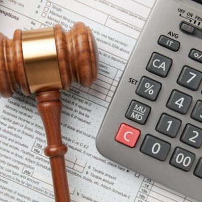 Tax return and calculator on white background with gavel Tax return and calculator on white background with gavel